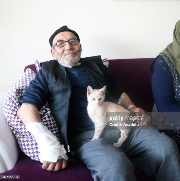 Year-old Ali Mese and the cat, saved by firefighters from a fire that broke out at old man's home after he tried to light a heating stove with...