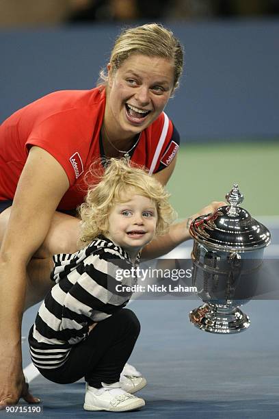 Kim Clijsters of Belgium and daughter Jada pose with the championship trophy after Clijsters defeated Caroline Wozniacki of Denmark in the Women�s...