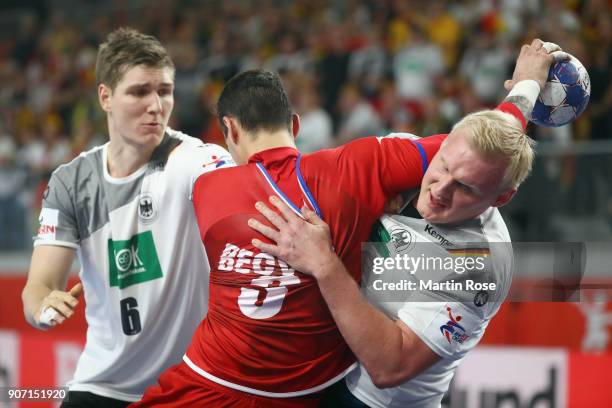 Roman Becvar of Czech Republic is challenged by Patrick Wiencek and Finn Lemke of Germany during the Men's Handball European Championship main round...