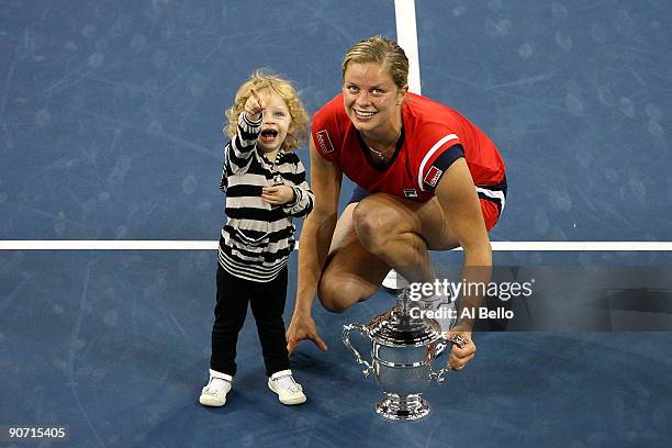 Kim Clijsters of Belgium and daughter Jada pose with the championship trophy after Clijsters defeated Caroline Wozniacki of Denmark in the Women�s...