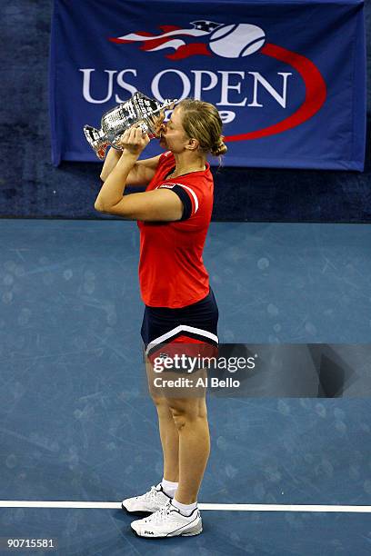 Kim Clijsters of Belgium kisses the championship trophy after defeating Caroline Wozniacki of Denmark in the Women�s Singles final on day fourteen of...