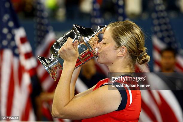 Kim Clijsters of Belgium kisses the championship trophy after defeating Caroline Wozniacki of Denmark in the Women�s Singles final on day fourteen of...