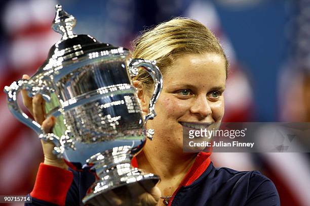 Kim Clijsters of Belgium poses with the championship trophy after defeating Caroline Wozniacki of Denmark in the Women�s Singles final on day...