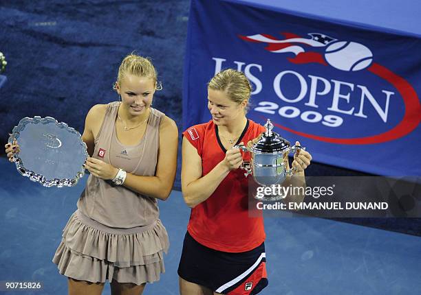 Tennis player Kim Clijsters from Belgium celebrates and Caroline Wozniacki from Denmark hold their trophy at the end of the Women's final of the 2009...