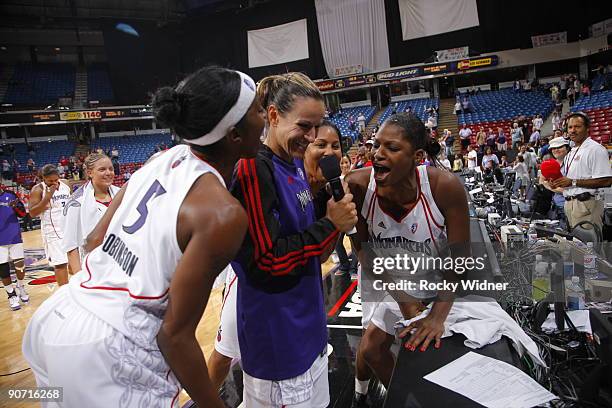 Ticha Penicheiro of the Sacramento Monarchs address the crowd with her teammates behind her after defeating the Minnesota Lynx on September 13, 2009...