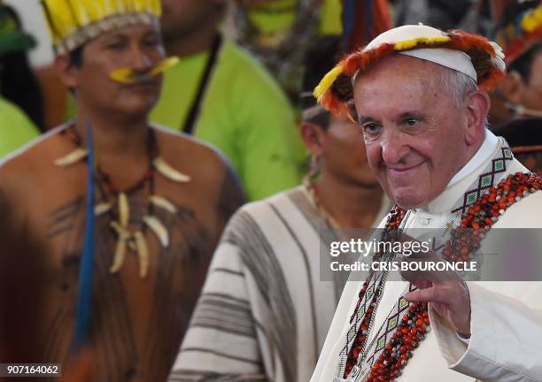 Pope Francis, wearing gifts, leaves after a meeting with representatives of indigenous communities of the Amazon basin from Peru, Brazil and Bolivia,...