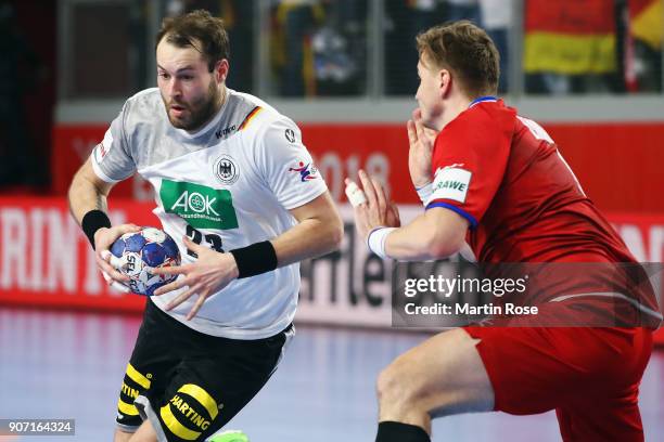 Steffen Faeth of Germany is challenged by Jan Landa of Czech Republic during the Men's Handball European Championship main round group 2 match...