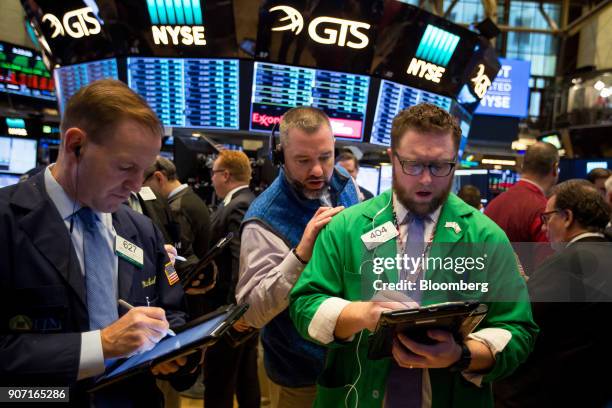 Traders work on the floor of the New York Stock Exchange in New York, U.S., on Friday, Jan. 19, 2018. U.S. Stocks meandered following a report that...