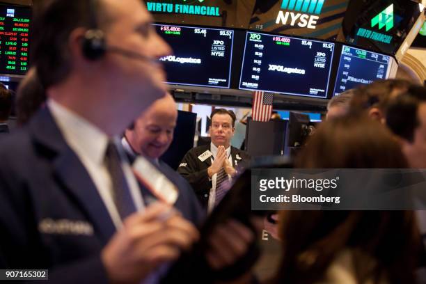 Traders work on the floor of the New York Stock Exchange in New York, U.S., on Friday, Jan. 19, 2018. U.S. Stocks meandered following a report that...