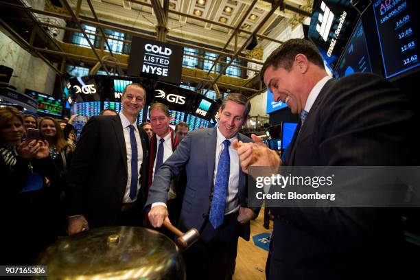 Timothy Whall, chief executive officer of ADT Inc., second right, rings in a ceremonial bell during the company's initial public offering on the...