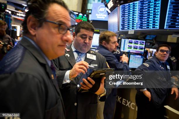 Traders work on the floor of the New York Stock Exchange in New York, U.S., on Friday, Jan. 19, 2018. U.S. Stocks meandered following a report that...