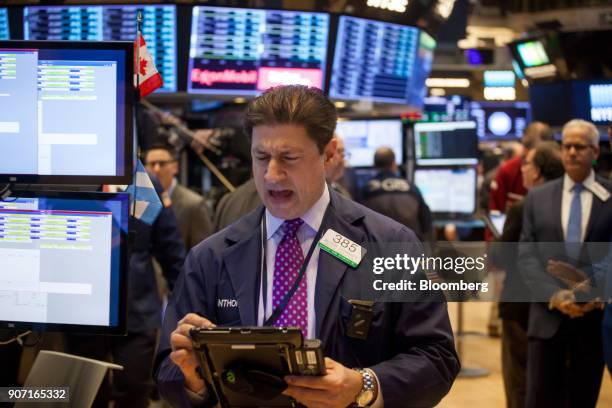 Trader works on the floor of the New York Stock Exchange in New York, U.S., on Friday, Jan. 19, 2018. U.S. Stocks meandered following a report that...