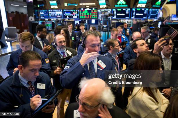 Traders work on the floor of the New York Stock Exchange in New York, U.S., on Friday, Jan. 19, 2018. U.S. Stocks meandered following a report that...