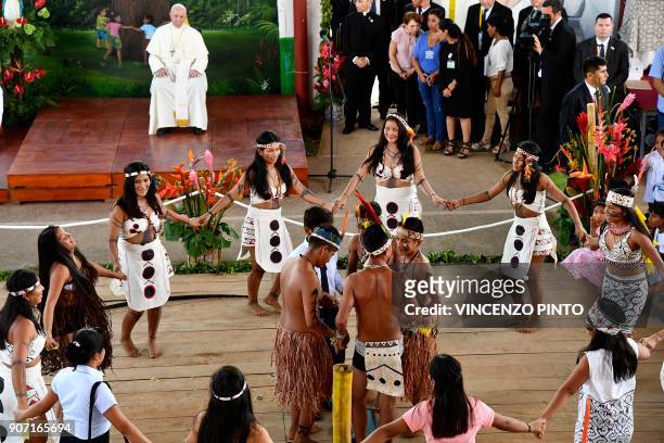 Pope Francis looks while children perform an indigenous traditional dance at "Hogar Principito" Children's home, in the Peruvian city of Puerto...