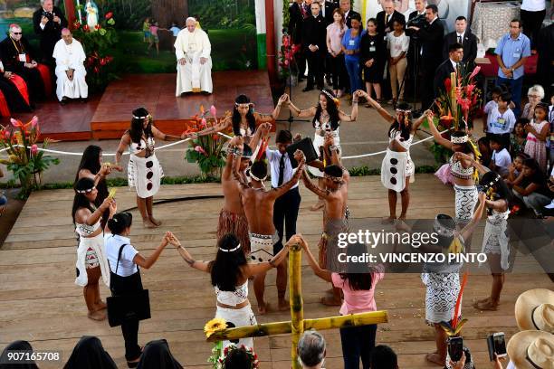 Pope Francis looks while children perform an indigenous traditional dance at "Hogar Principito" Children's home, in the Peruvian city of Puerto...