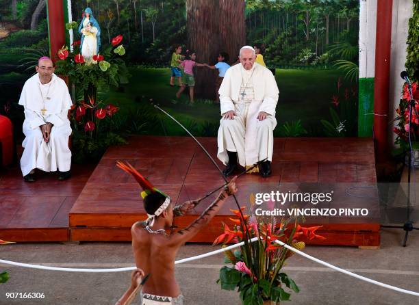 Pope Francis looks at the performance of an indigenous boy during his visit at "Hogar Principito" Children's home, in the Peruvian city of Puerto...