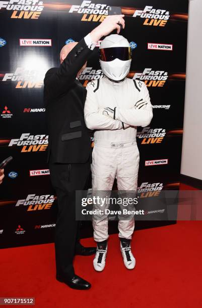 The Stig poses with a guest at the Global Premiere of "Fast and Furious Live" at The O2 Arena on January 19, 2018 in London, England.