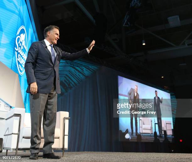 Former Massachusetts Governor and Republican presidential candidate Mitt Romney waves as he leaves the stage at the Silicon Slopes Tech Conference on...