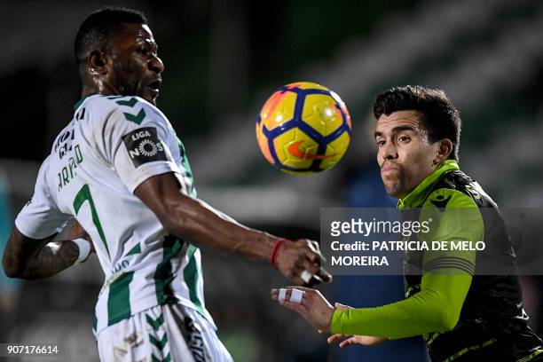 Sporting's Argentinian forward Marcos Acuna vies with Vitoria Setubal's Congolese forward Arnold Issoko during the Portuguese league football match...