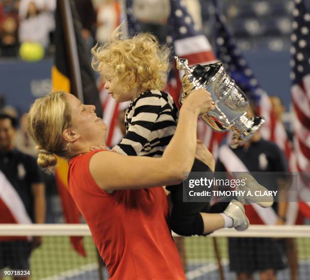 Kim Clijsters from Belgium and her daughter Jada with her trophy after defeating Caroline Wozniacki from Denmark to win the Women's Final US Open...