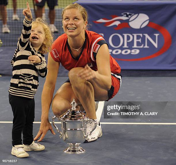 Kim Clijsters from Belgium and her daughter Jada with her trophy after defeating Caroline Wozniacki from Denmark to win the Women's Final US Open...