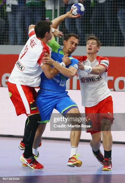 Darko Cingesar of Slovenia is challenged by Rasmus Lauge Schmidt and Lasse Svan of Denmark during the Men's Handball European Championship main round...