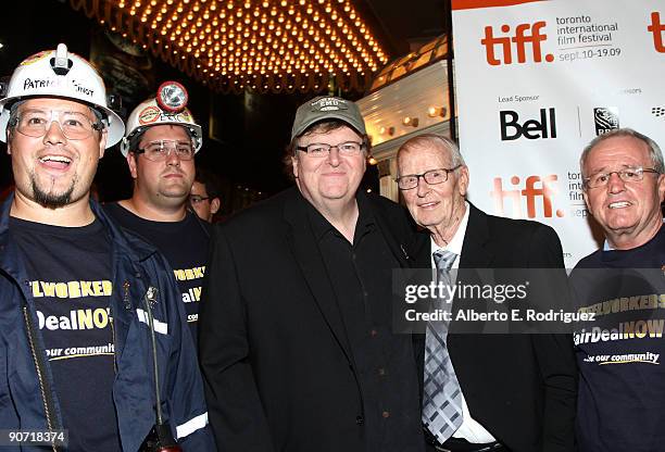 Writer/director Michael Moore and father Frank pose with protesting local steel workers at the "Capitalism: A Love Story" screening during the 2009...