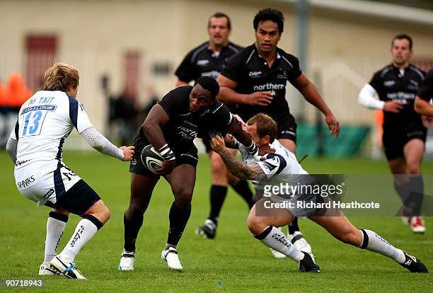 Gcobani Bobo of Newcastle is tackled by Matthew Tait and Lee Thomas of Sale during the Guinness Premiership match between Newcastle Falcons and Sale...