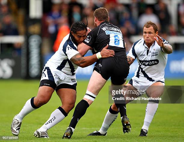 Ed Williamson of Newcastle is tackled by Andy Tuilagi and Lee Thomas of Sale during the Guinness Premiership match between Newcastle Falcons and Sale...