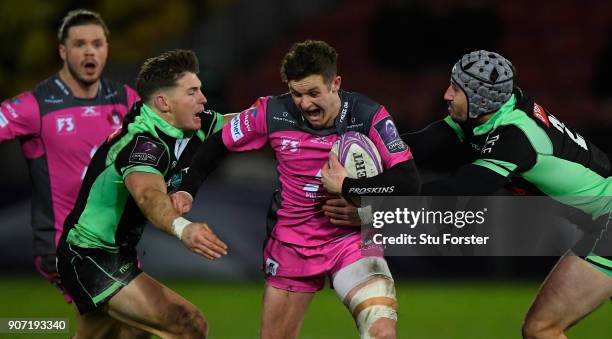 Billy Burns of Gloucester runs through the tackle of Colin Slade and Florian Nicot of Paloise during the European Rugby Challenge Cup match between...