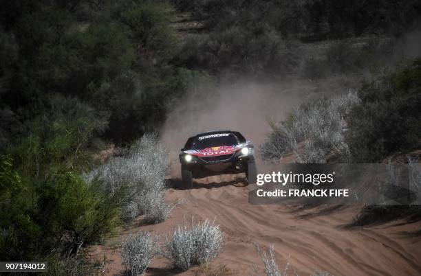 Peugeot's Spanish drivers Carlos Sainz and co-driver Lucas Cruz compete during Stage 13 of the 2018 Dakar Rally between San Juan and Cordoba,...