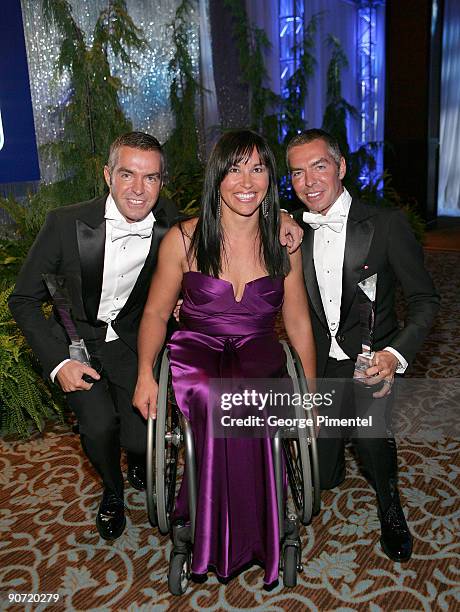 Designers Dean Caten and Dan Caten pose with Paralympic athlete Chantel Petitclerc during the 2009 RBC Inductee Charity Ball at the Sheraton Centre...