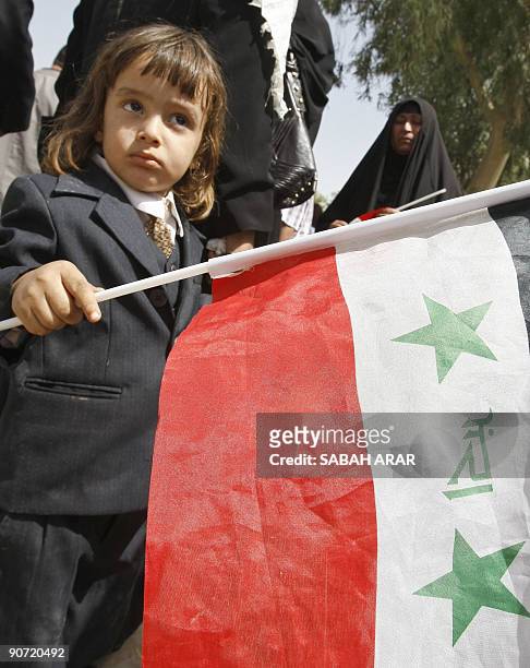 Young relative holds the Iraqi flag as he waits for the release of jailed Iraqi television journalist Muntazer al-Zaidi in central Baghdad, on...