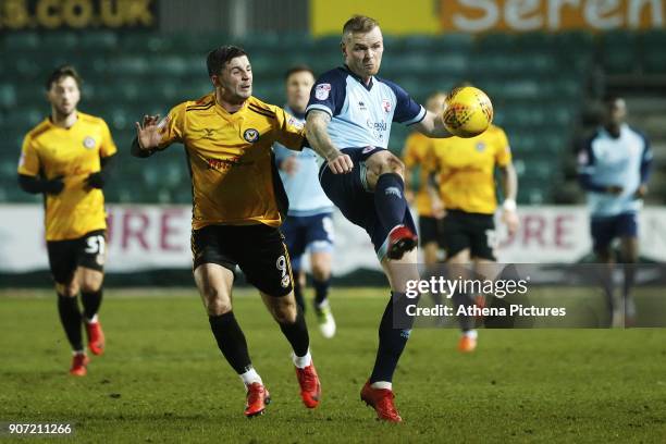 Mark Connolly of Crawley Town is challenged by Padraig Amond of Newport County during the Sky Bet League Two match between Newport County and Crawley...