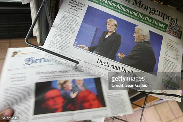 In this photo illustration a man pulls out a newspaper from a rack of newspapers with covers featuring Social Democrat , Vice Chancellor and Foreign...
