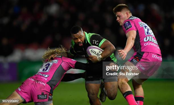 Billy Twelvetrees and Freddie Clarke of Gloucester attempt to halt the run of Steffon Armitage of Paloise during the European Rugby Challenge Cup...