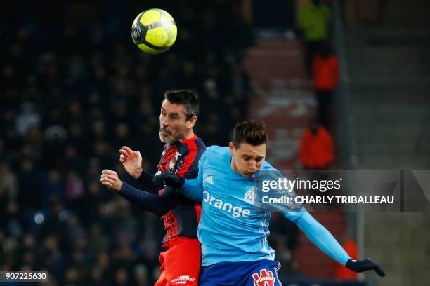 Caen's French midfielder Julien Feret vies for the ball with Olympique de Marseille's French midfielder Florian Thauvin during the French L1 football...