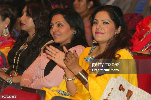 Punjabi women watch and clap as contestants compete in the Giddha folk dance segment during the Miss World Punjaban beauty pageant held in...