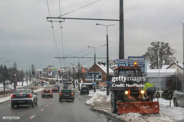 Worker in the old Polish URSUS tractor snow-clearing sidewalk is seen in Gdynia, Poland on 19 January 2018 Heavy snow fall and wind Power has been...