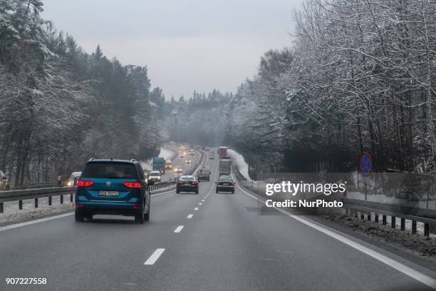 Blue Volkswagen Touran in the winter scenery of the Tricity Ringroad is seen in Gdansk, Poland on 19 January 2018 Heavy snow fall and wind Power has...
