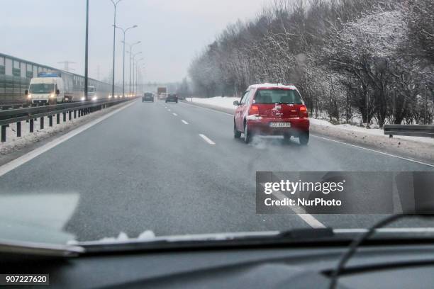Red Volkswagen Lupo covered by the snow at the Tricity ringroad is seen in Gdansk, Poland on 19 January 2018 Heavy snow fall and wind Power has been...
