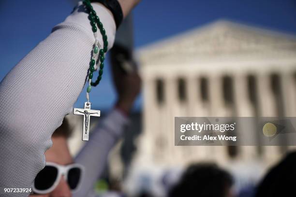 Pro-life activist holds up a rosary as he passes in front the U.S. Supreme Court during the 2018 March for Life January 19, 2018 in Washington, DC....