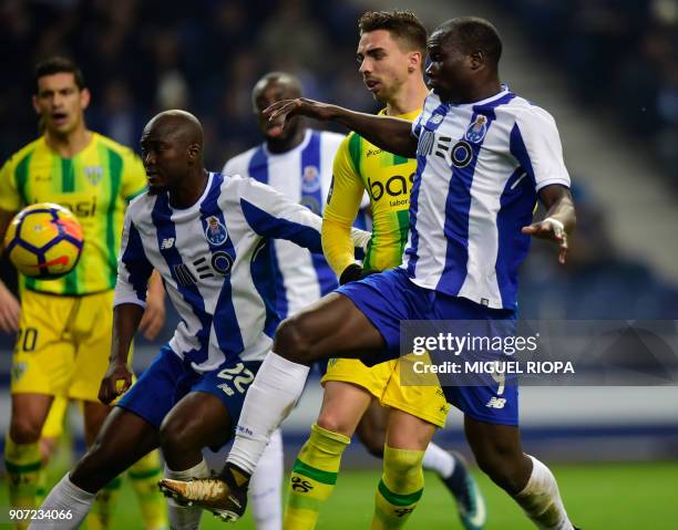 Porto's Cameroonian forward Vincent Aboubakar vies with Tondela's Portuguese forward Tomane beside teammate Porto's Portuguese midfielder Danilo...