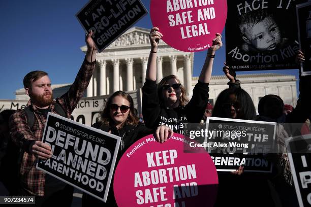 Pro-life activists try to block the signs of pro-choice activists in front of the the U.S. Supreme Court during the 2018 March for Life January 19,...