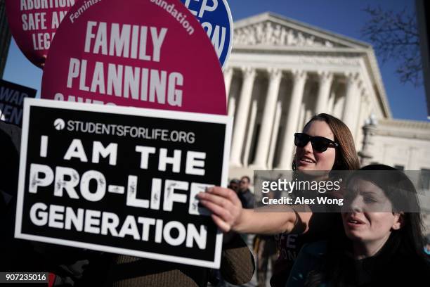 Pro-life activist tries to block the signs of pro-choice activists in front of the the U.S. Supreme Court during the 2018 March for Life January 19,...