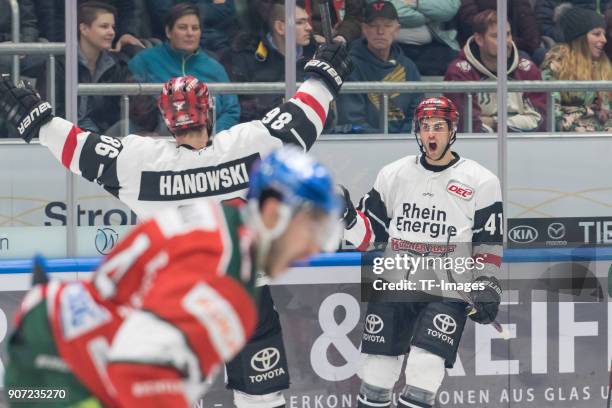 Ben Hanowski of Koelner Haie and Justin Shugg of Koelner Haie celebrate their team`s first goal during the DEL match between Augsburger Panther and...