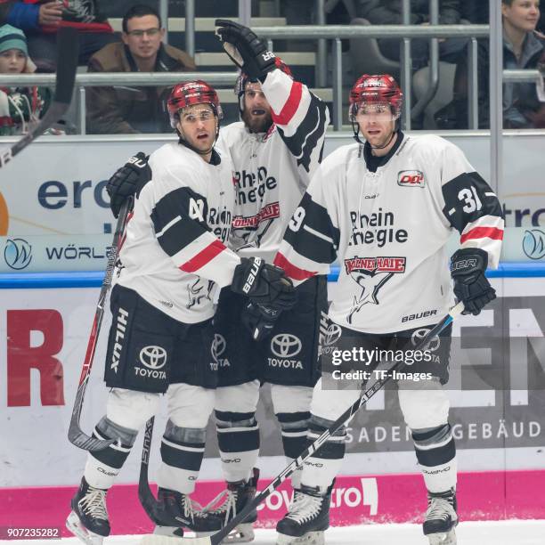 Justin Shugg of Koelner Haie, Ben Hanowski of Koelner Haie and Martin William Thomas of Koelner Haie celebrate their team`s first goal during the DEL...