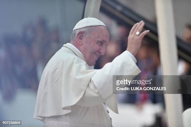 Pope Fracis waves to the crowd from the popemobile as he leaves the Presidential Palace and heads to Saint Peter's Church in Lima on January 19,...