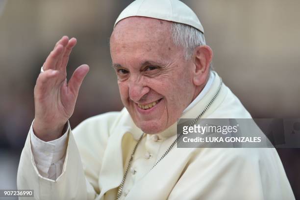 Pope Fracis waves to the crowd from the popemobile as he leaves the Presidential Palace and heads to Saint Peter's Church in Lima on January 19,...