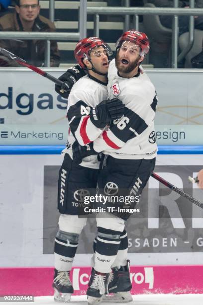 Justin Shugg of Koelner Haie and Ben Hanowski of Koelner Haie celebrate their team`s first goal during the DEL match between Augsburger Panther and...